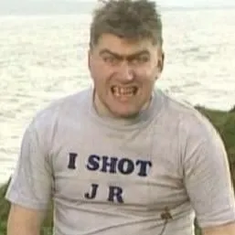 screencap of Tom in "I shot JR" t-shirt from the TV show Father Ted