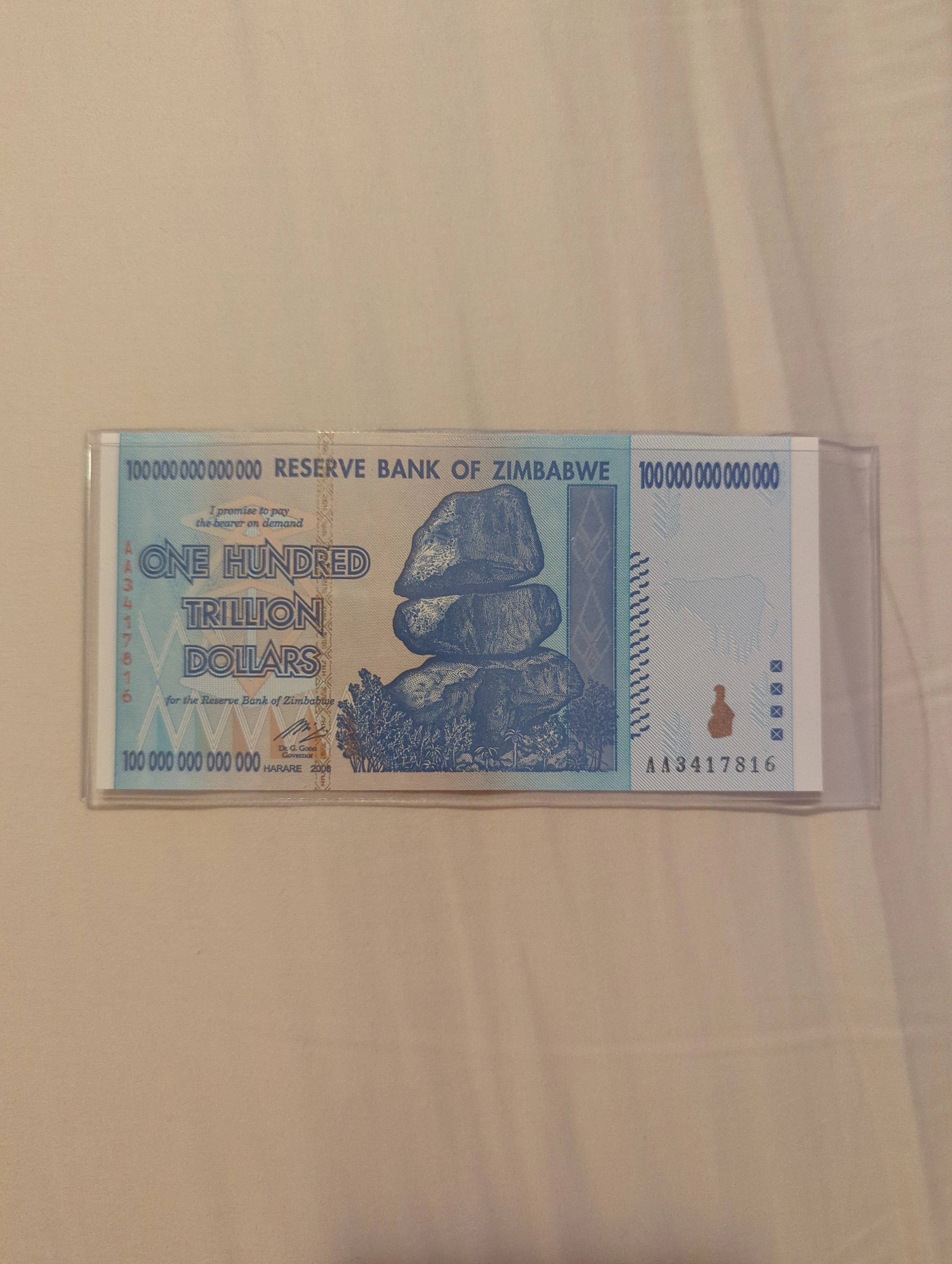 Picture of my vast fortune (100 000 000 000 000 dollar bill from Zimbabwe)